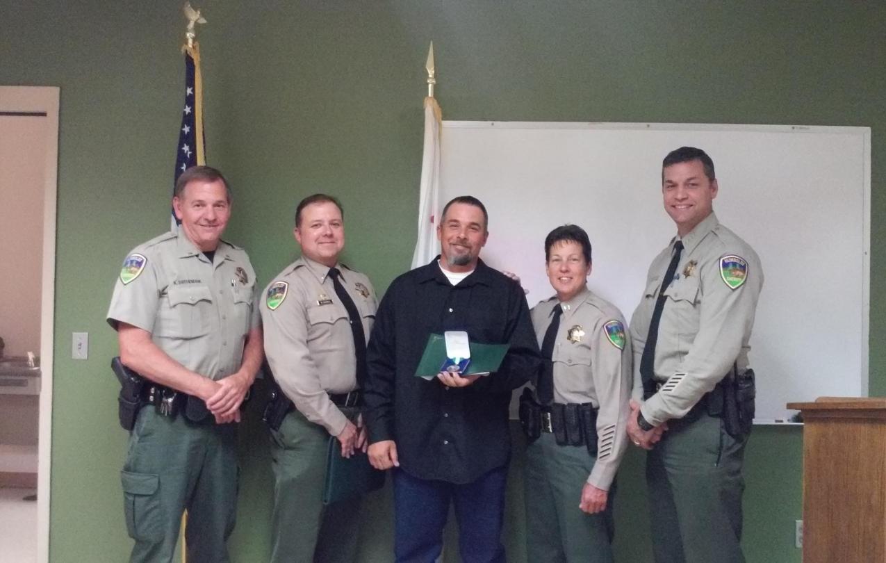 From left to right: Lt. Ken Swithenbank, Lt. Bryan Quenell, John Marciel, Captain Kym Thompson and Sheriff William Honsal.