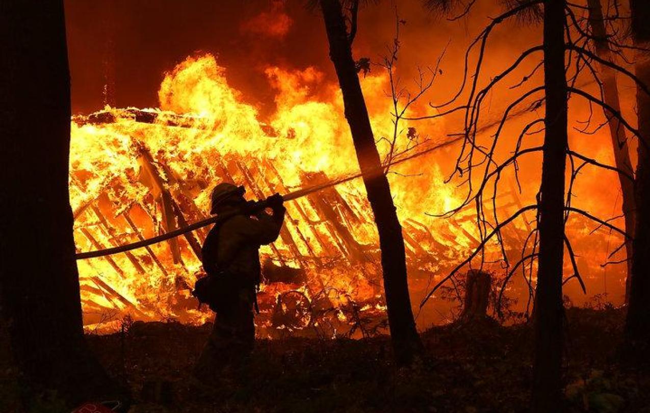 Firefighters work in dangerous conditions to fight the fast-moving fires in northern and southern California. (Justin Sullivan/Getty Images)