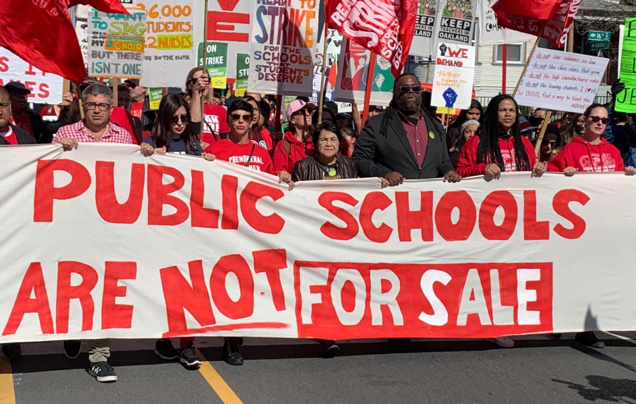 LABOR ICON DOLORES HUERTA (CENTER, WITH BLACK JACKET) HELPS LEAD A MARCH IN SUPPORT OF OAKLAND TEACHERS. (PHOTO CREDIT: JO BATES)