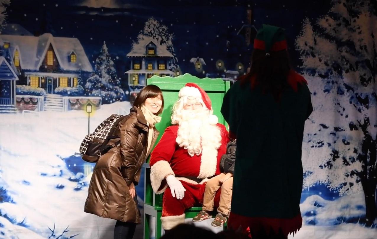 A family takes a photo with Santa during the Holiday Tree Lighting Ceremony in Santa Clara.