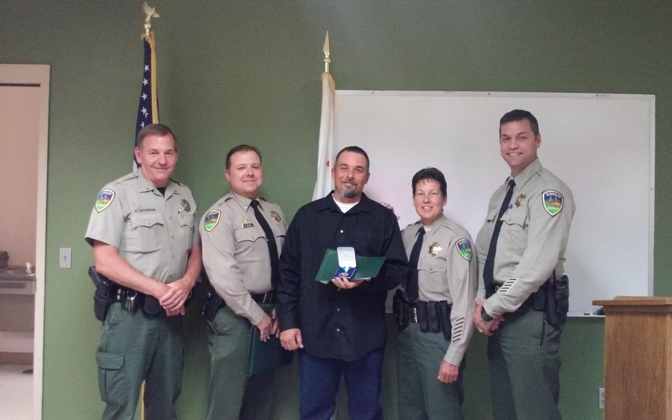 From left to right: Lt. Ken Swithenbank, Lt. Bryan Quenell, John Marciel, Captain Kym Thompson and Sheriff William Honsal.