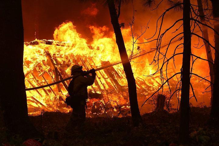 Firefighters work in dangerous conditions to fight the fast-moving fires in northern and southern California. (Justin Sullivan/Getty Images)