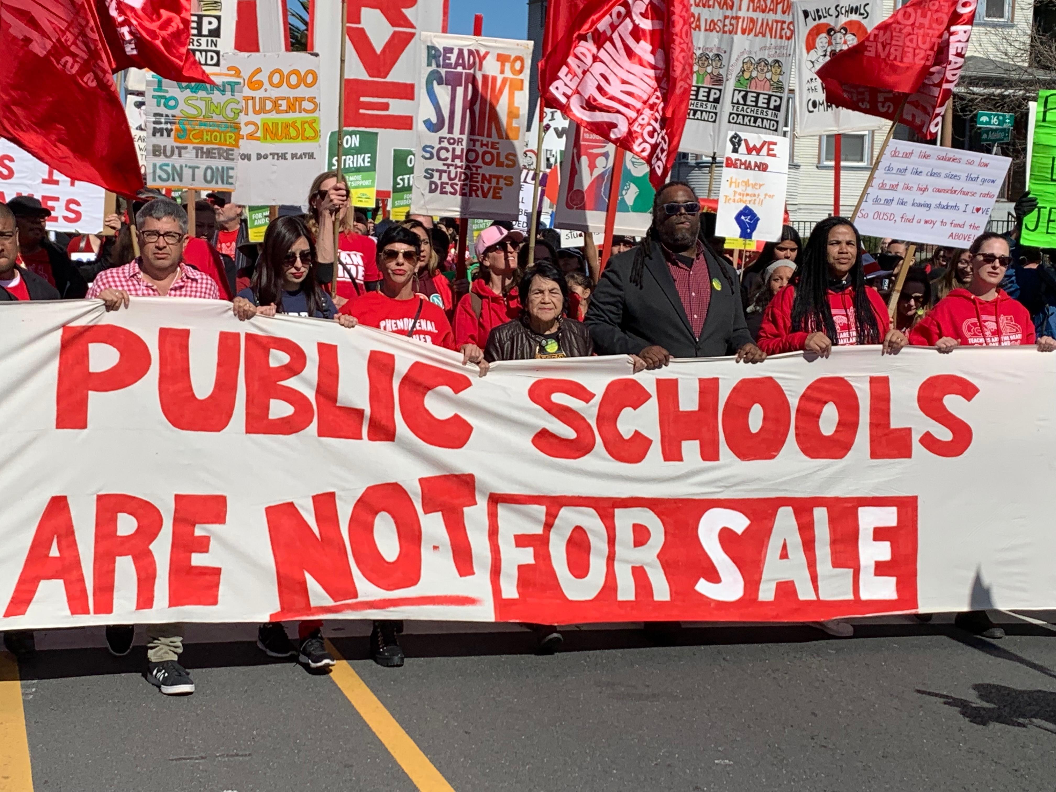 LABOR ICON DOLORES HUERTA (CENTER, WITH BLACK JACKET) HELPS LEAD A MARCH IN SUPPORT OF OAKLAND TEACHERS. (PHOTO CREDIT: JO BATES)