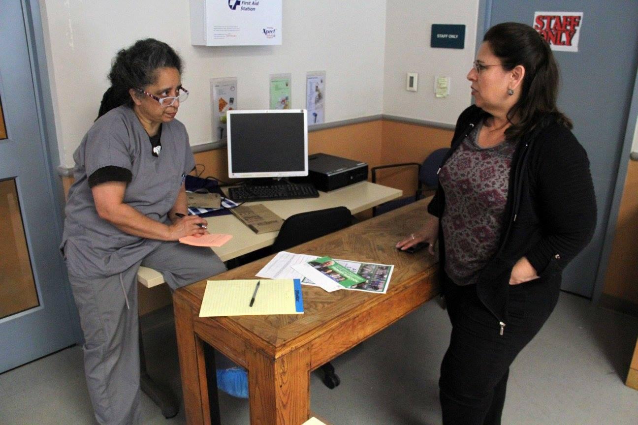 A member talks to a worker about the benefits of joining the union during an AFSCME Strong blitz.